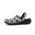 Black women's platform sandals with rhinestone detail on an EVA upper and a textured injection-moulded sole.