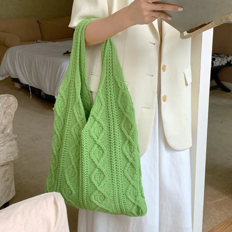 Retro crochet women's tote bag with double shoulder straps in a grass green colour, showing textured knit detail.