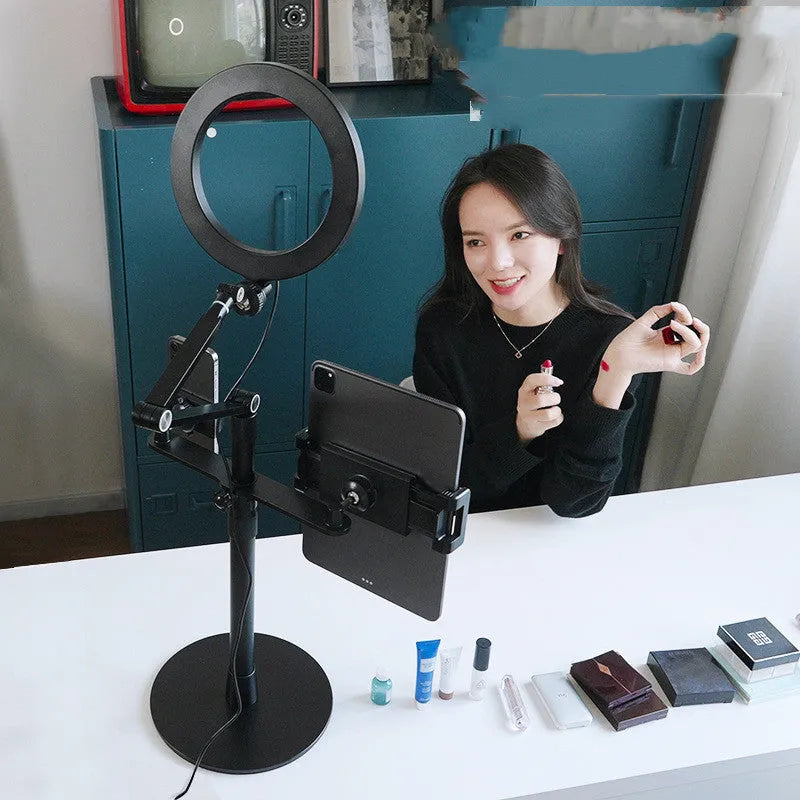 Black mobile phone tablet stand with fill light attachment in folded position showing rotation mechanism