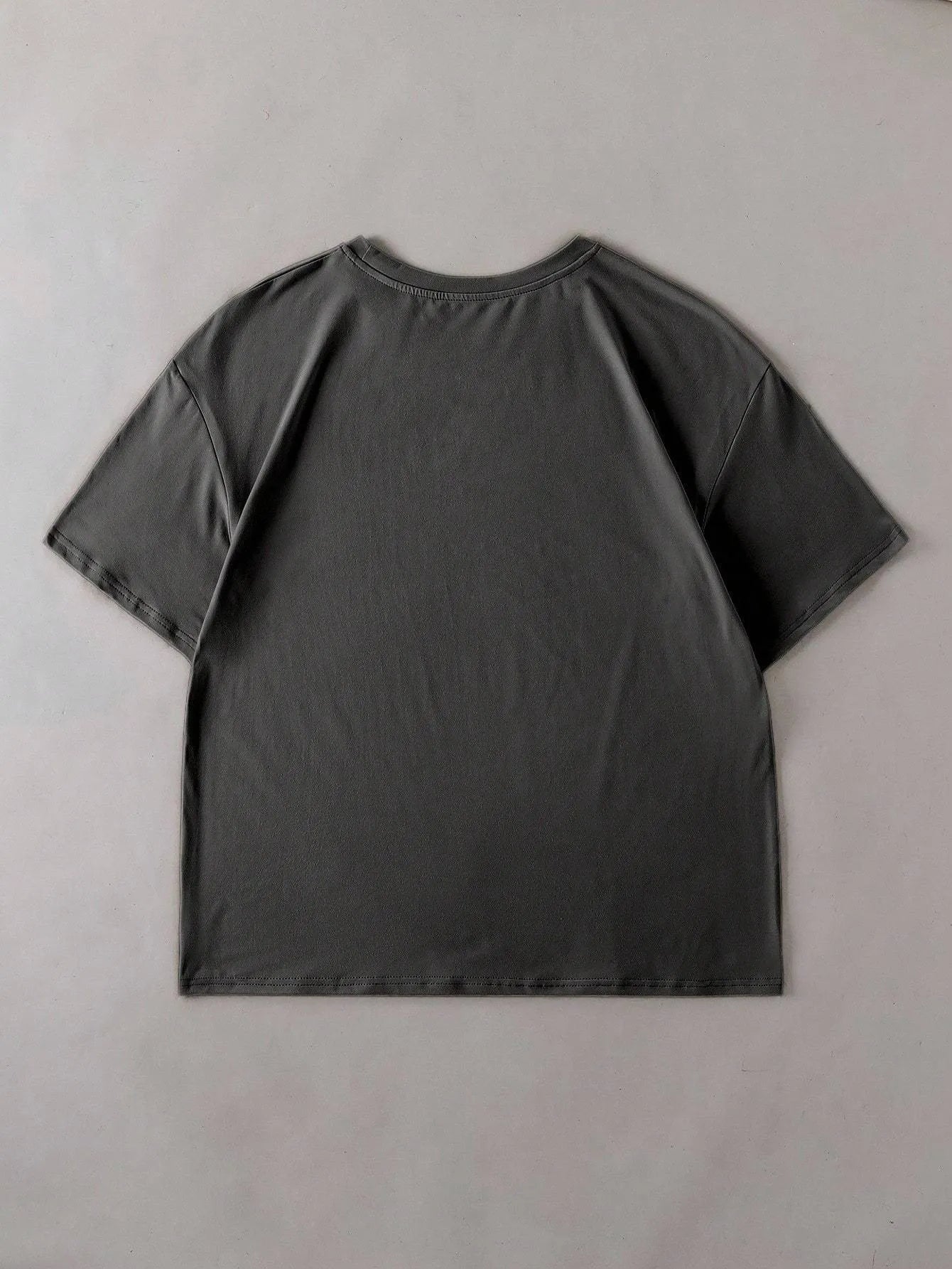 Straight cut loose summer t-shirt in cotton fabric on a hanger.