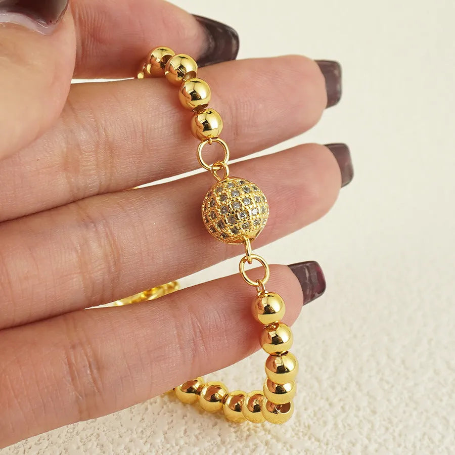 Arabic-style women's copper bracelet with a heart-shaped zircon ornament on a model's wrist.