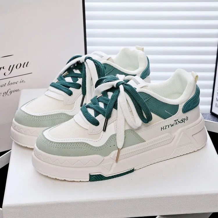 Beige children's lace-up board shoes with cross shoulder straps and a thick rubber sole, shown on a white background.