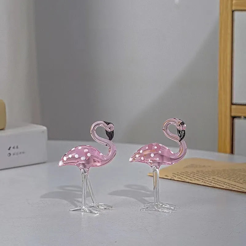Pink flamingo crystal decorative ornament on a table in modern minimalist style.