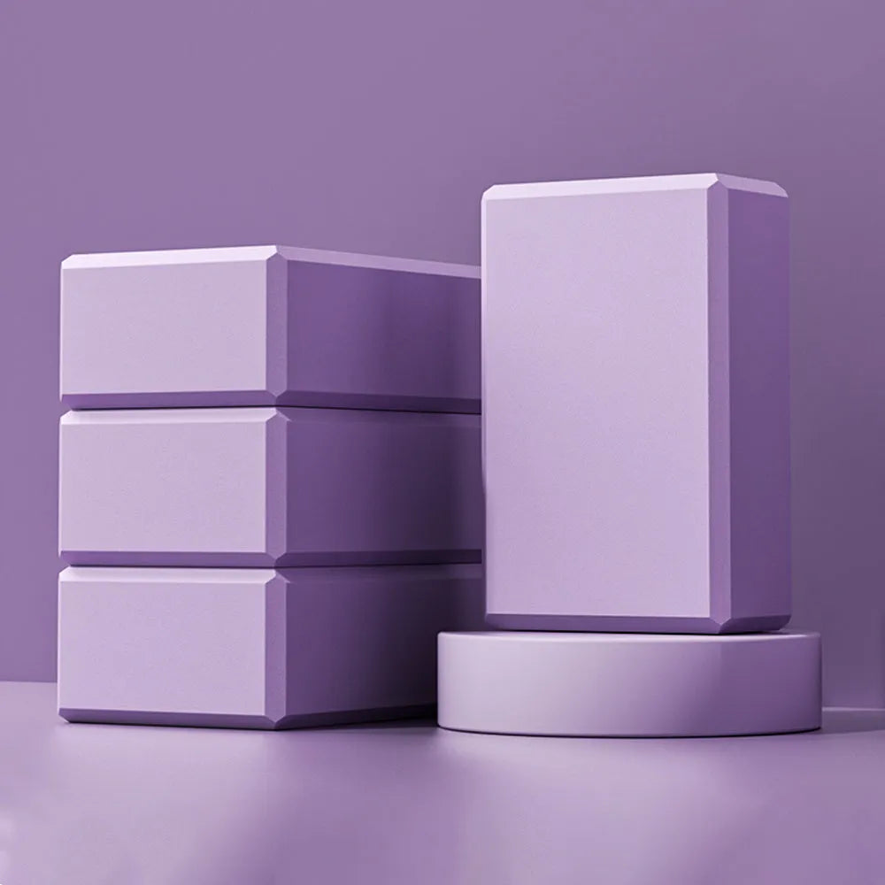 Solid colour EVA foam yoga block on a yoga mat, showing dimensions of 23x15x7.6 cm