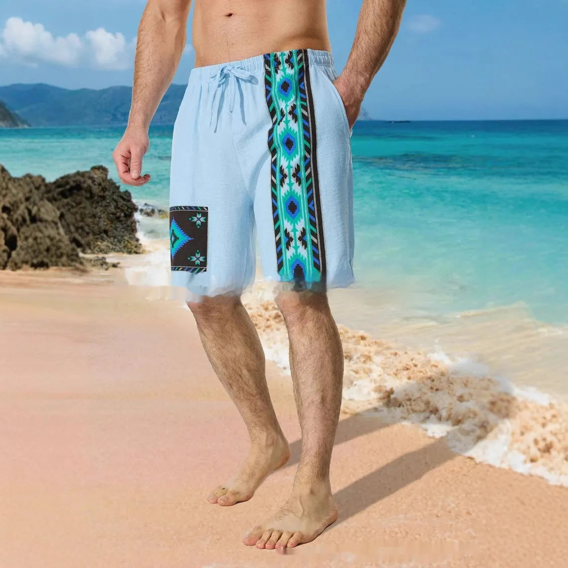 Man wearing blue loose-fitting casual shorts with a digital colour block pattern and a drawstring waist.