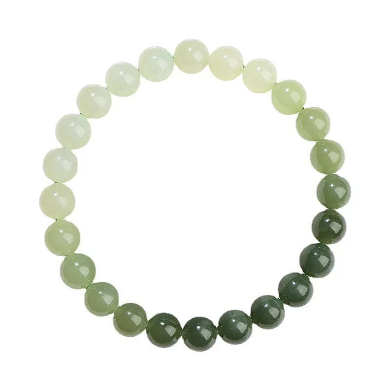 Natural clear water Hetian jade bracelet with gradient round beads on a wrist.