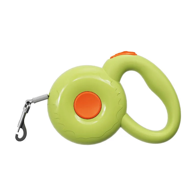 Retractable dog leash with reflective rope in green colour on a wooden floor