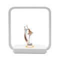 Blue atmosphere table lamp with integrated wireless phone charging pad on bedside table