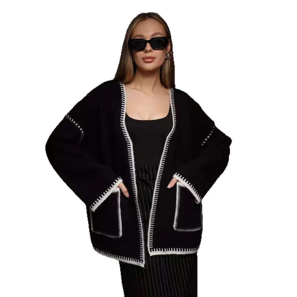 Loose fit lace-up knitted cardigan in black, shown as a mid-length sweater coat.