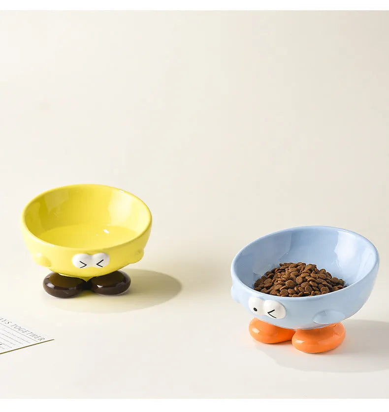 Cute Expression tall slanted ceramic pet food bowl in blue and yellow colours for cats and dogs
