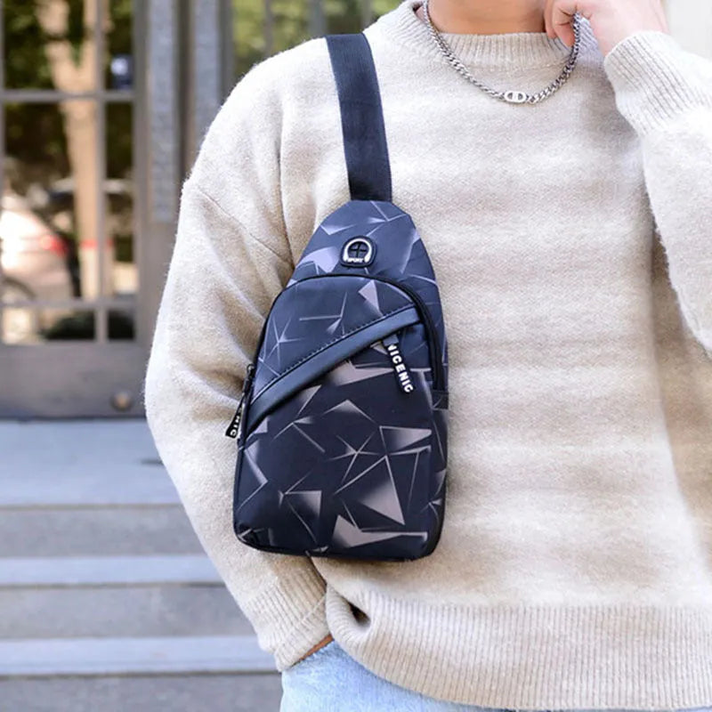 Men's blue print sling chest bag with a visible earphone hole and a single adjustable strap.
