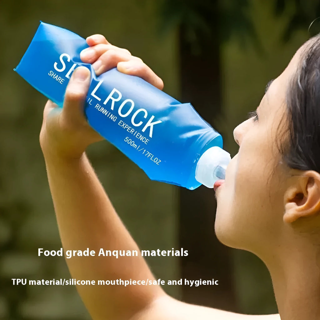 Flexible silicone drinking straw with black carabiner clip against outdoor background
