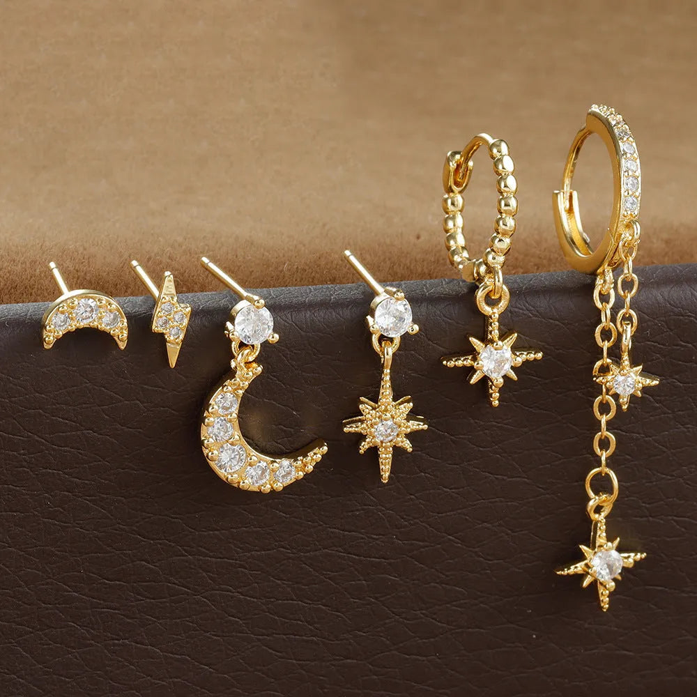 Six gold chain tassel earrings with zircon studs arranged as a complete jewellery set