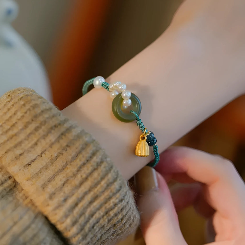 Hand-woven flexible wire watch bracelet with pearl peace buckle closure on wrist