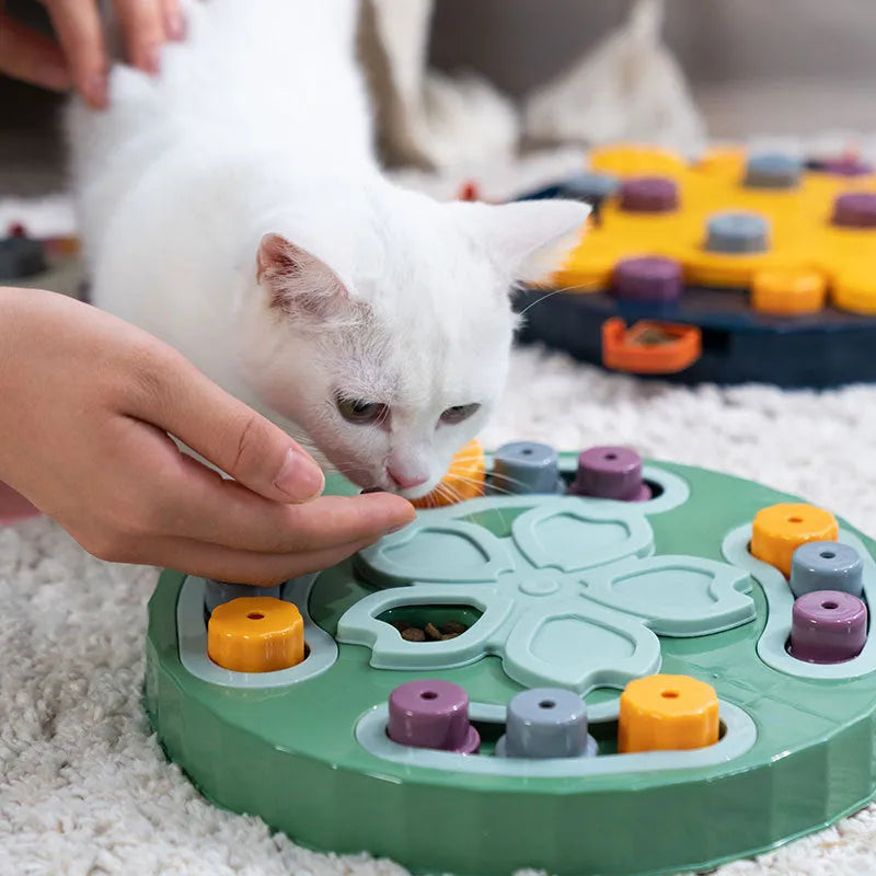 Blue interactive dog slow feeder toy with rotating central pillar on a non-slip base