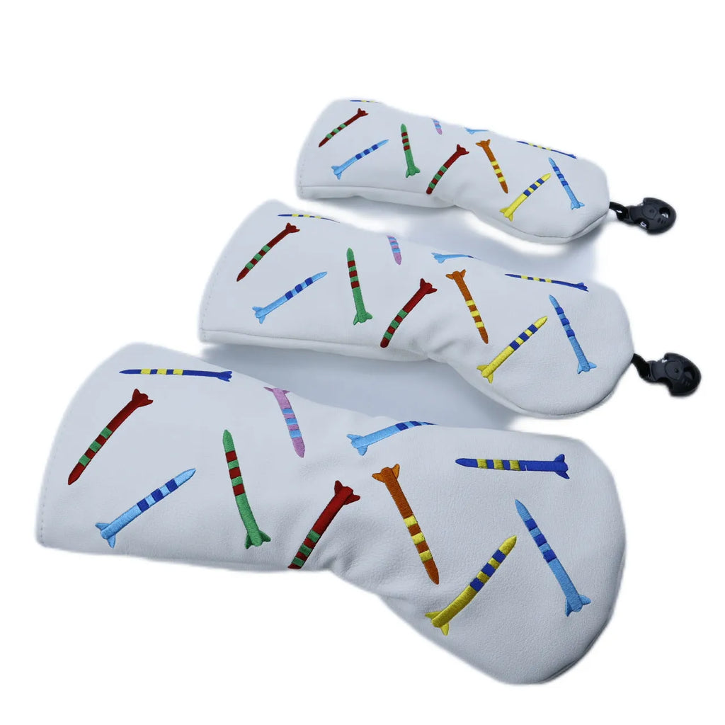 Set of three black golf putting practice clubs in large, medium, and small sizes on a green.