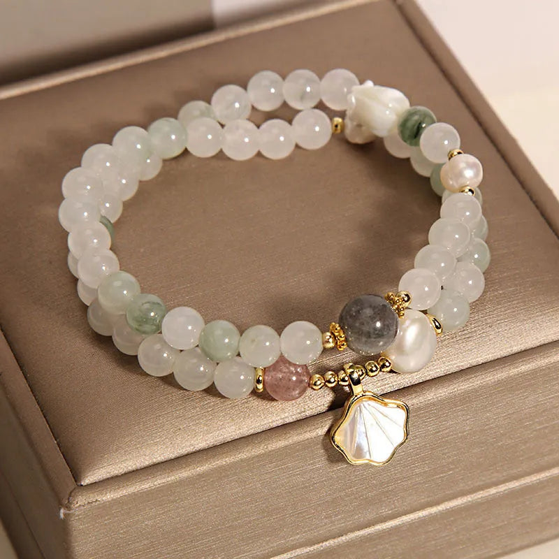 Women's crystal bracelet with Tianshan Jade ginkgo leaf pendant and gold-plated inlay.