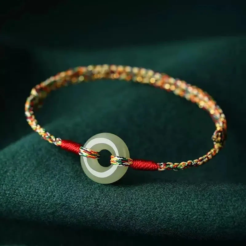 Colourful woven rope bracelet with silver peace buckle closure on wrist