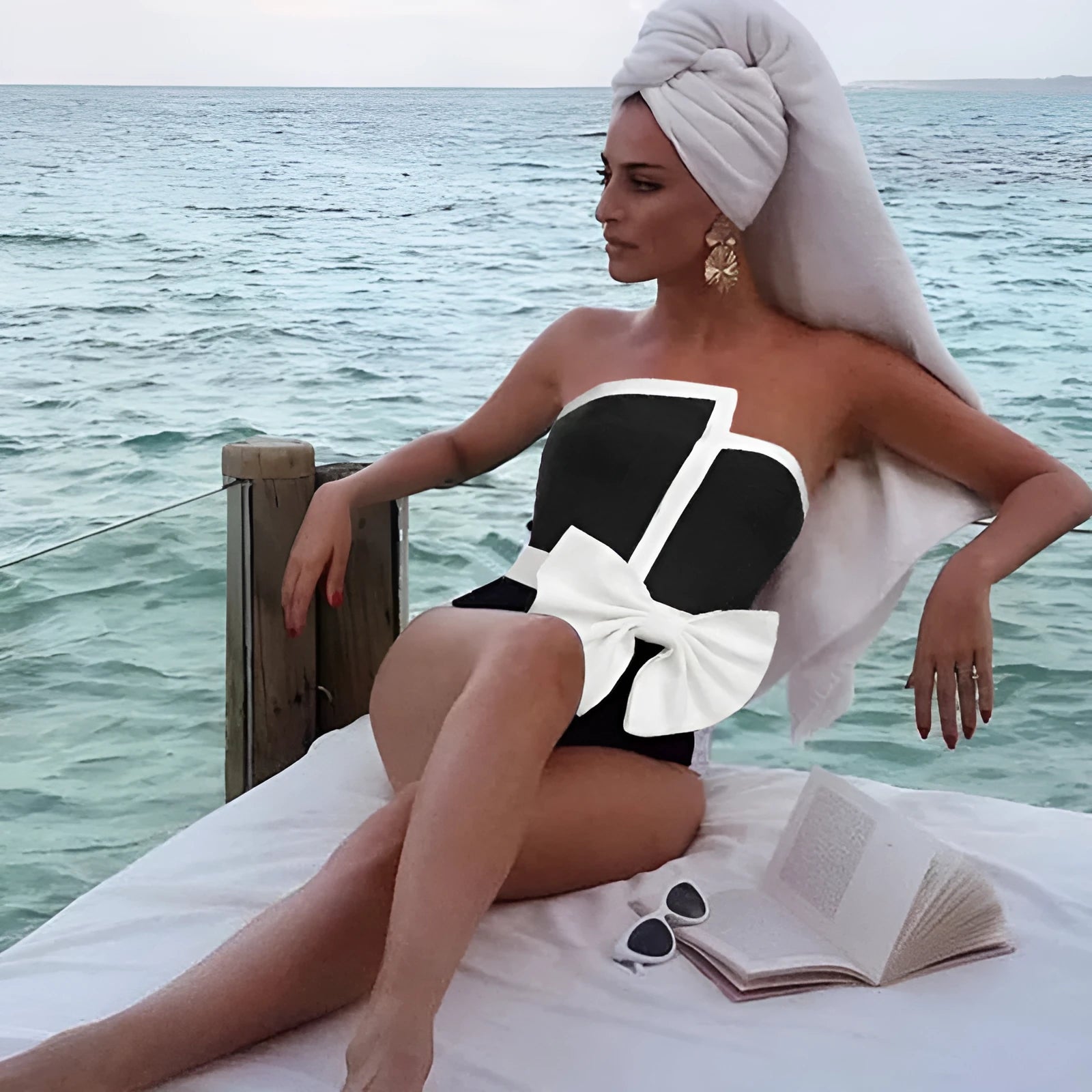 Women's black and white colour-block one-piece swimsuit with asymmetrical bow detail and tube top design