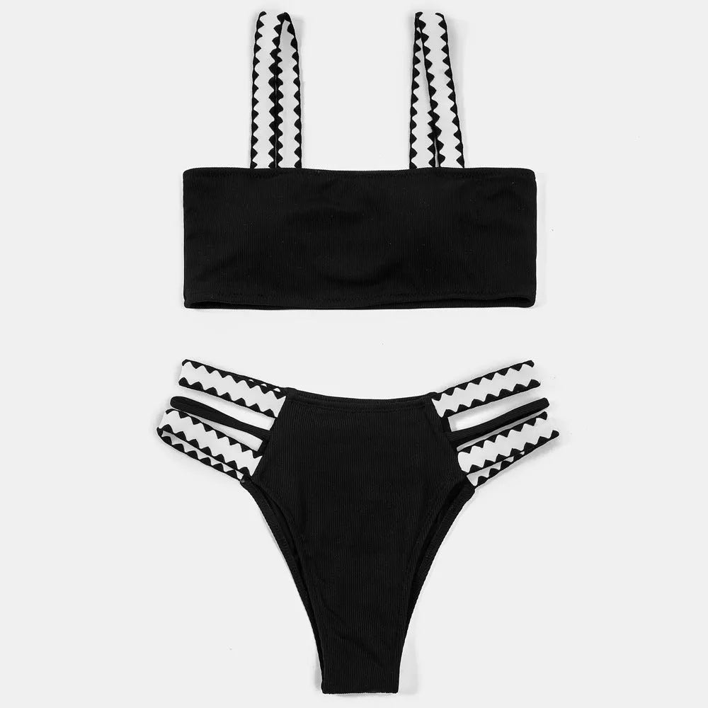Black women's hollowed-out split swimsuit bikini on a neutral background