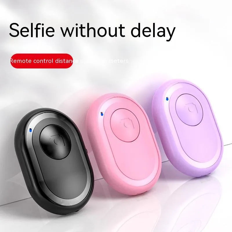 Wireless Bluetooth remote control for smartphone photography in black, pink, or purple colours