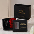 Red Valentine's gift box containing six pink soap flowers, with a matching red handbag alongside.