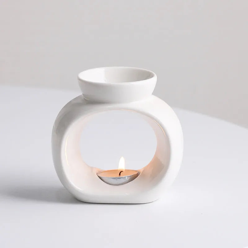 White retro Nordic ceramic aromatherapy stove ornament on a surface.