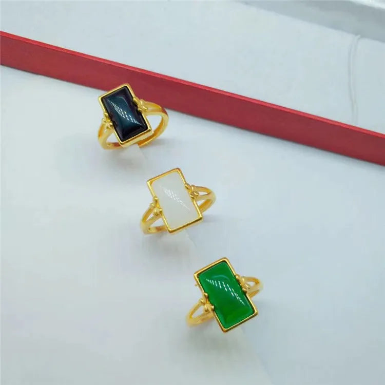 Adjustable brass gold-plated ring with a green gemstone inlay, showing national style design