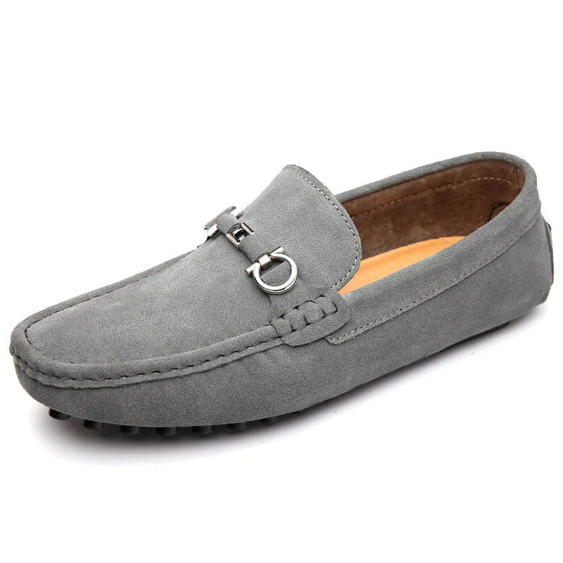 Men's black slip-on leather shoes with square toe and flat rubber sole on a neutral background.
