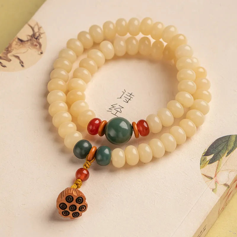 Women's cream topaz Bodhi wooden bracelet with flat round beads on a 15-20cm wrist.