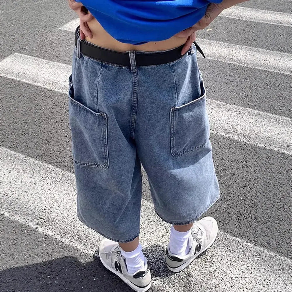 Blue washed denim men's shorts with a high waist and cropped, straight-leg pirate style.
