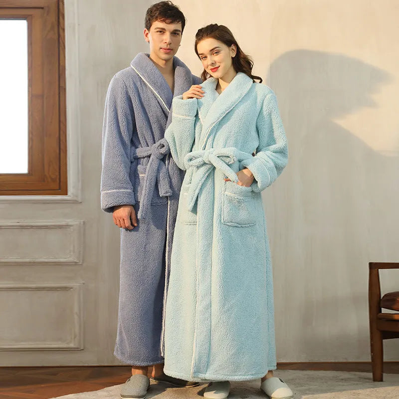 A man and woman wearing matching thick navy blue flannel bathrobes, ankle-length winter nightgown style.