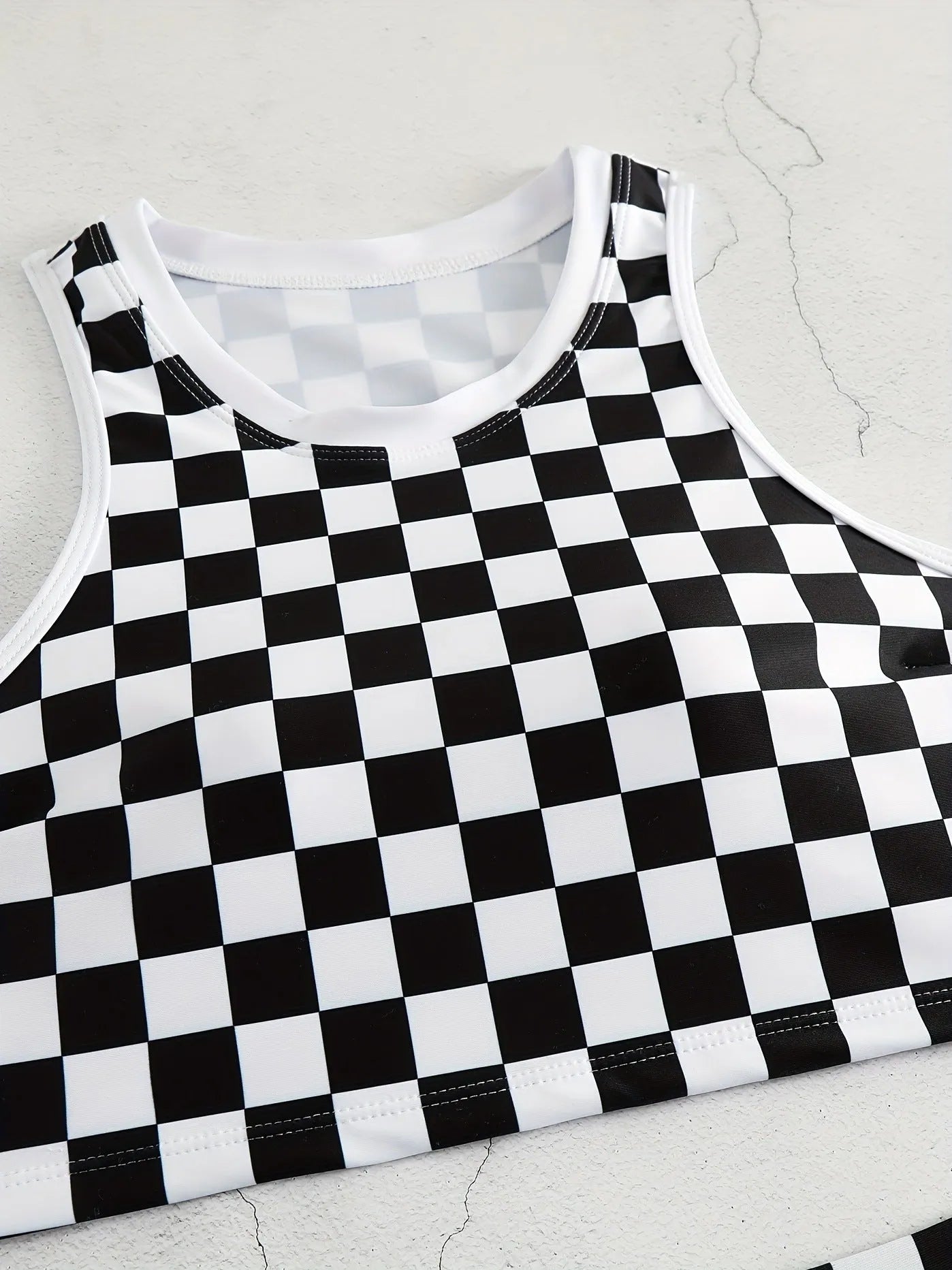 Women's racing one-piece swimsuit with suspender straps and chessboard pattern