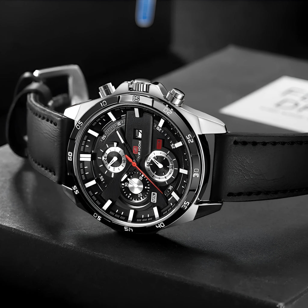 Men's black leather strap watch with rose gold case and calendar window on dial.