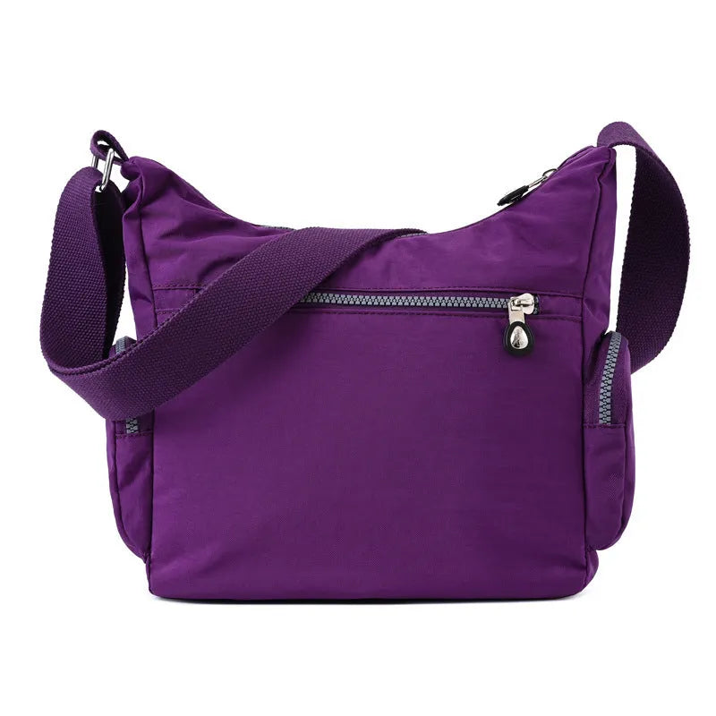 Women's waterproof nylon crossbody shoulder bag in black with multiple pockets and telescopic handle