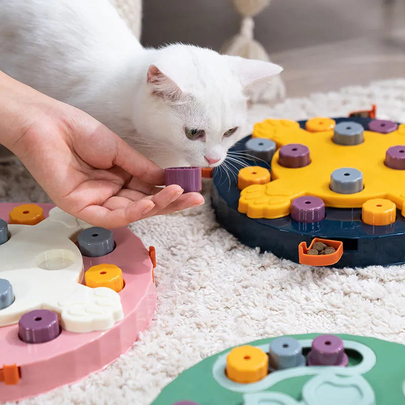 Blue interactive dog slow feeder toy with rotating central pillar on a non-slip base