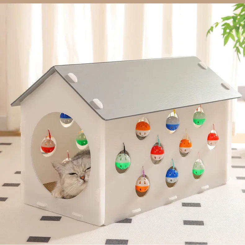 White plastic cat scratch board with integrated round nest bed and short tunnel with dangling bell ball