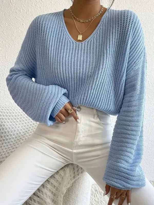 A woman's solid colour long sleeve pullover jumper in a loose, casual fit.