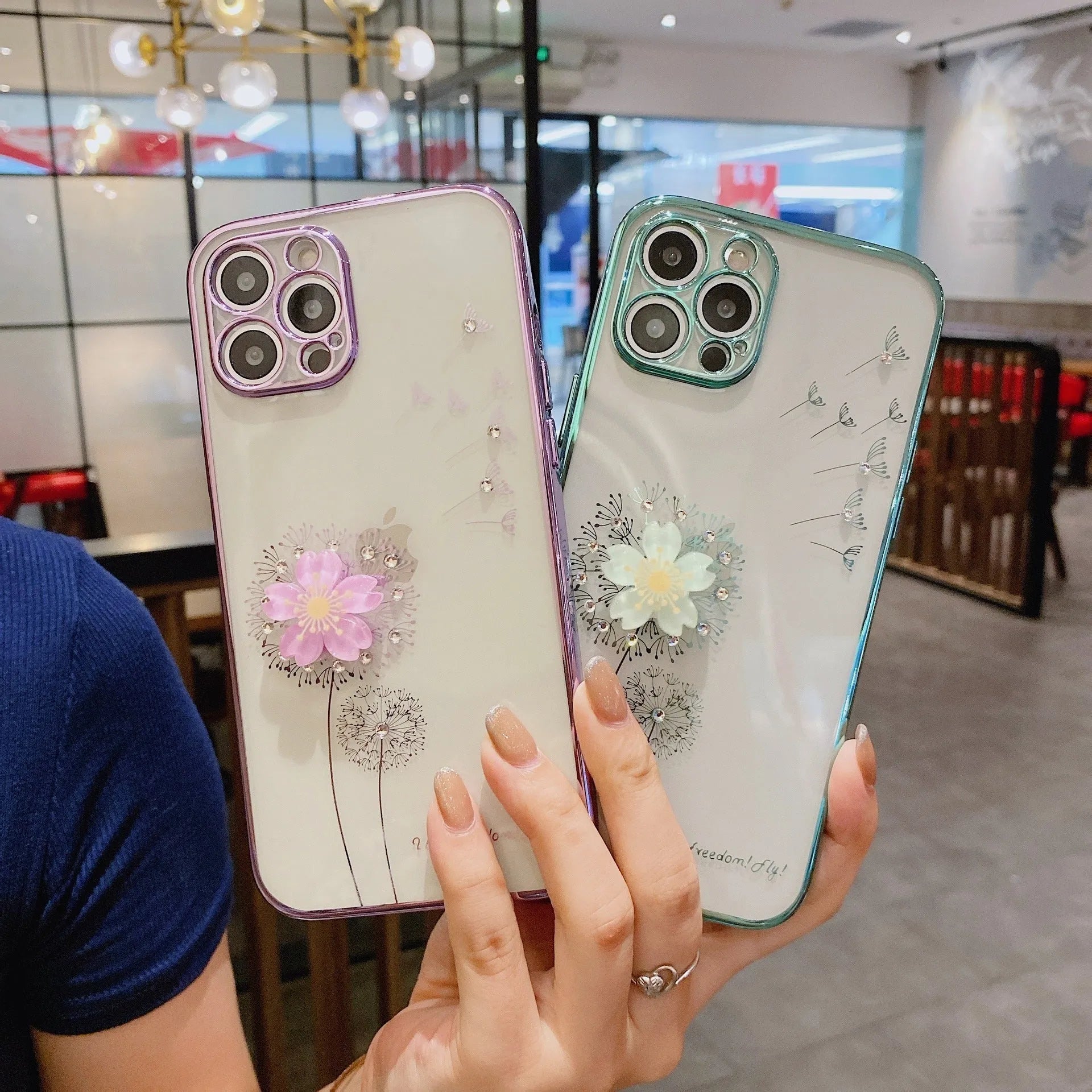 Green iPhone case with 3D white floral design and a silver rotating kickstand extended at the back.