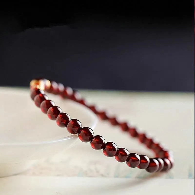 Wine red glass bead garnet bracelet with new Chinese style design showing single circle configuration
