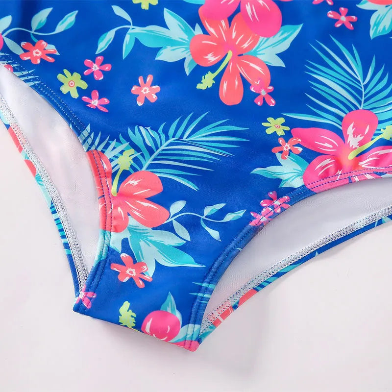 Girl's long sleeve one-piece swimming costume in a bright colour on a hanger