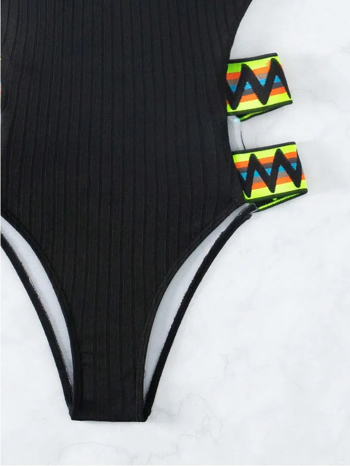 Solid colour black women's one-piece swimsuit made from polyester fabric on a neutral background.