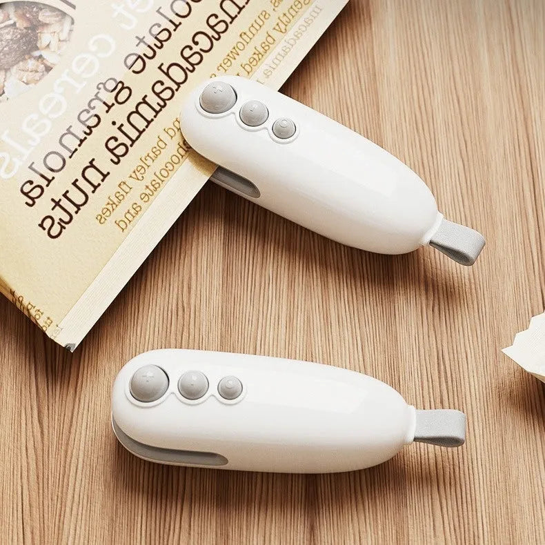 Mini automatic electric thermal sealing machine in ivory white with USB cable, ABS body, 12.2cm length