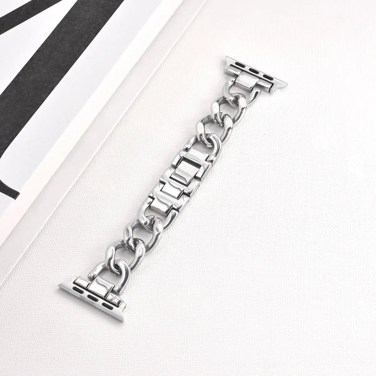 Metal denim chain watch strap for Apple Watch in multiple colours on a grey background.