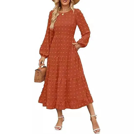 A beige high-waisted long sleeve dress with ruffled sleeves on a hanger.
