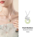 Silver pendant necklace with a peace buckle design on an adjustable cross chain.
