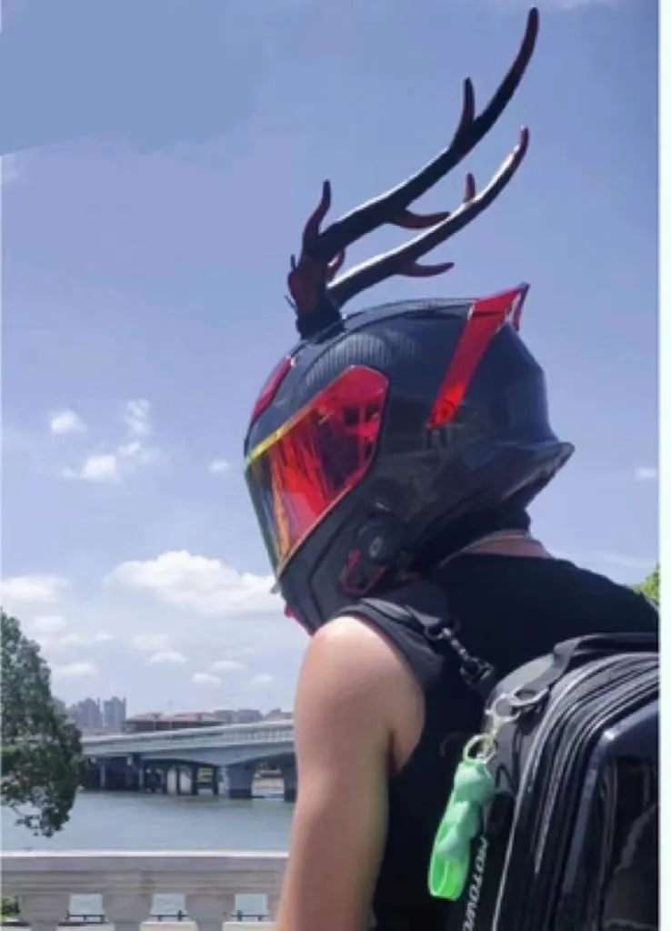 Pair of resin dragon horn decorations for motorcycle helmet in black and red finish, showing scale.
