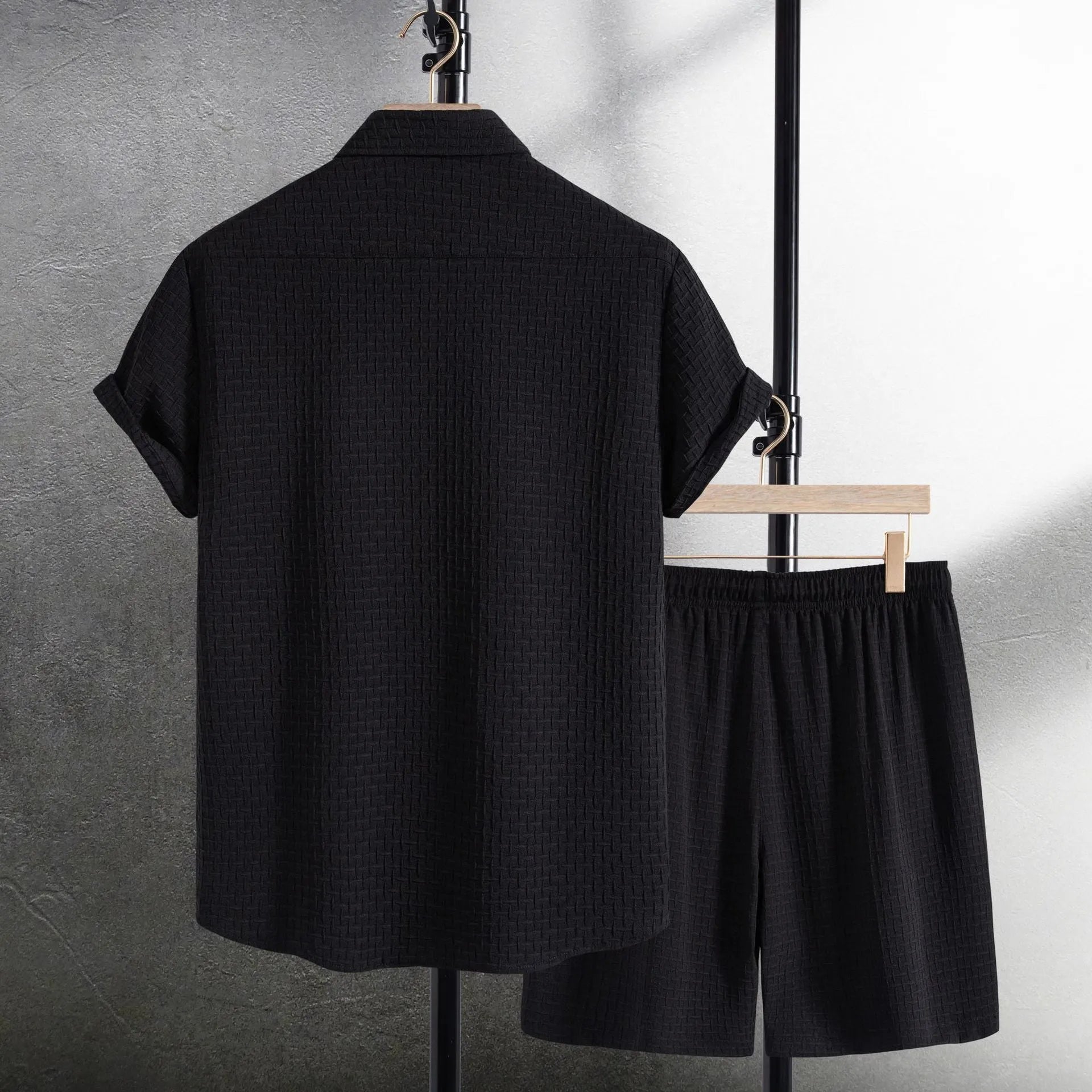 Men's white cotton blend beach shorts suit with short sleeve shirt on a hanger.
