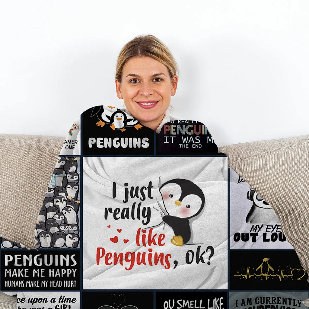 Multicoloured penguin flannel velvet throw blanket on sofa with hemmed edges