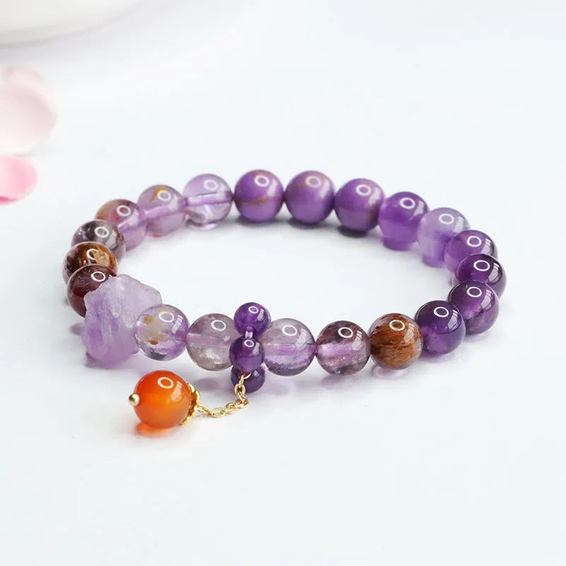 Nine purple amethyst and red agate crystal bracelet showing 8mm beads and Mori style design